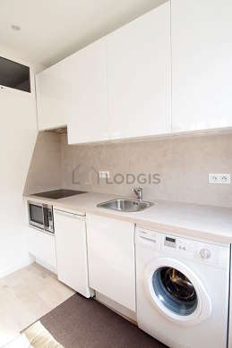 Kitchen equipped with washing machine, refrigerator, freezer, extractor hood