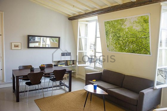 Quiet living room furnished with tv, cupboard, 4 chair(s)